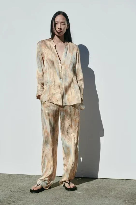 Stylish asymmetric tie-dye shirt and straight-leg trousers set in vibrant colors, perfect for the modern Kiwi wardrobe.