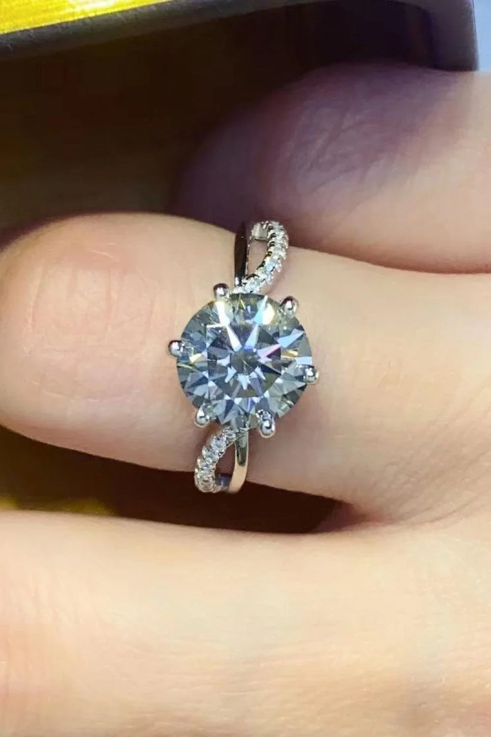 Closeup of a 2-Carat Moissanite Ring in a smokey gray colour, set in 925 sterling silver with sparkling zircon accent stones