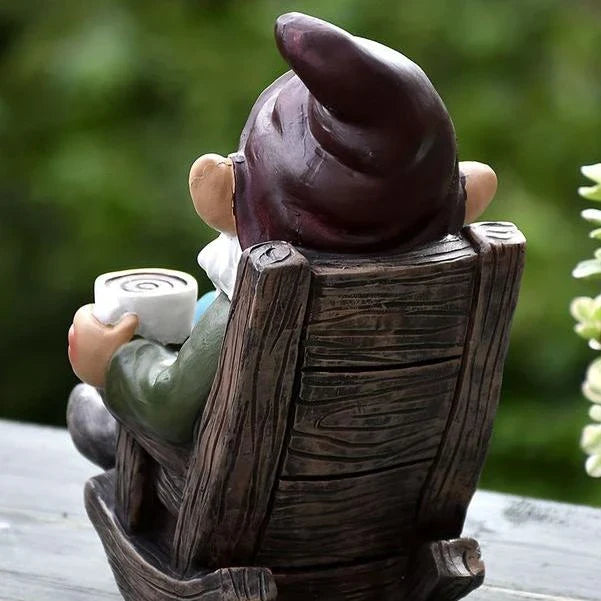 Charming outdoor gnome ornament in a rocking chair, perfect for adding whimsical personality to Kiwi gardens and patios