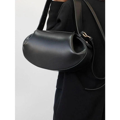 A stylish circular vegan leather handbag with a unique rugby-inspired design, perfect for Kiwi fashion enthusiasts