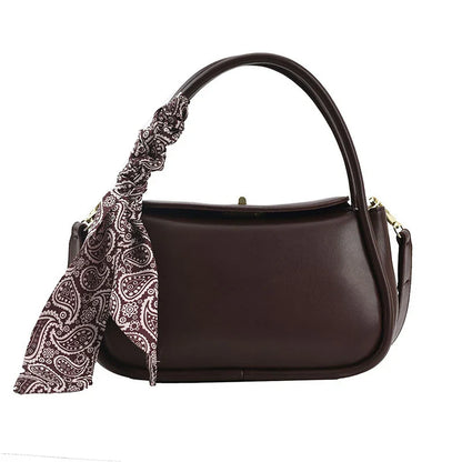 Premium silk scarf handbag in a variety of Kiwi-approved colours, featuring a magnetic buckle closure and oval shape for ample storage.