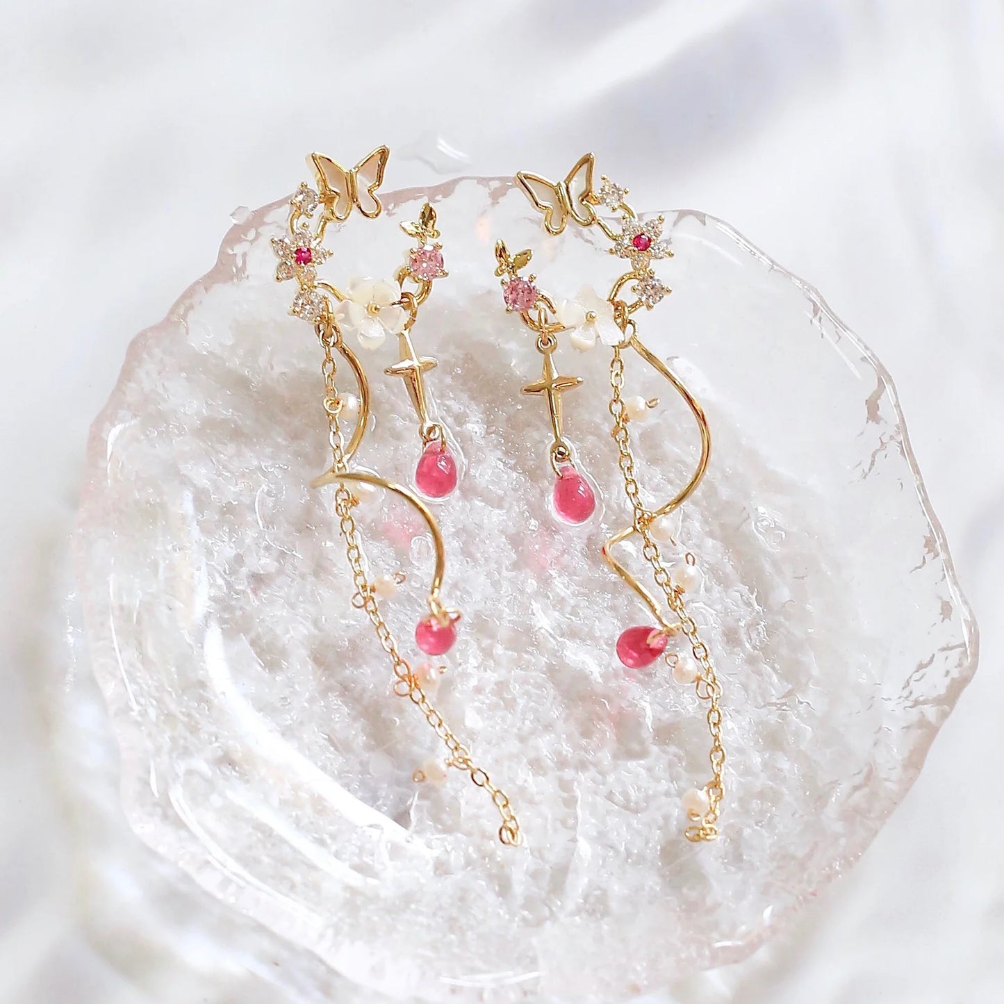 Elegant sterling silver and gold-plated earrings adorned with iridescent freshwater pearls