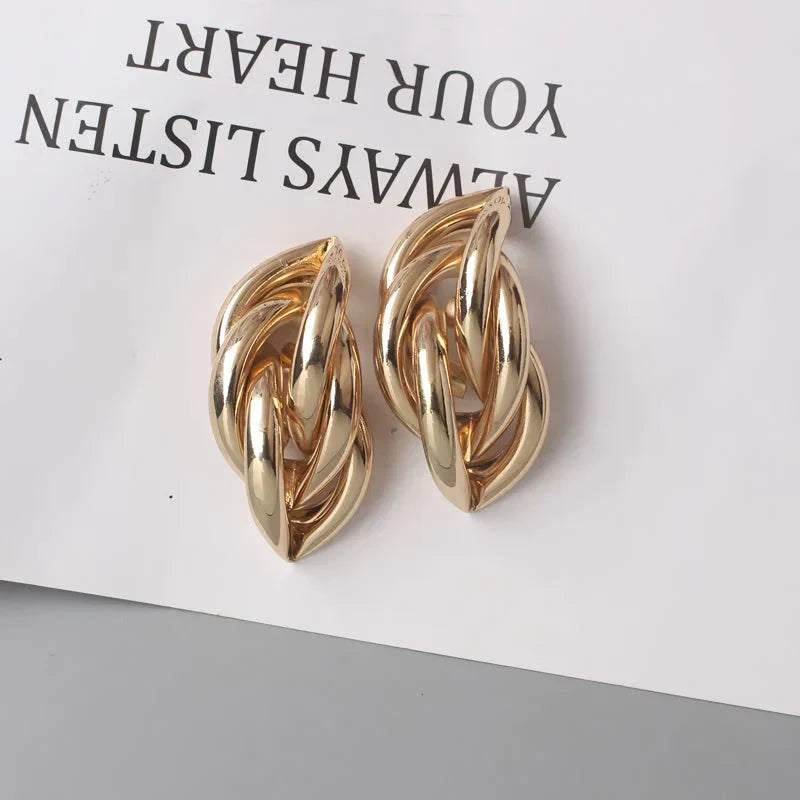 Geometric statement earrings in a luxurious gold finish, featuring a unique hollow twist design for a bold, fashionable look