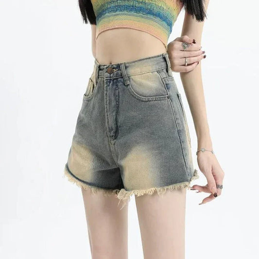 High-waist vintage denim shorts in a straight fit, with pockets, buttons, and zipper closure for a classic, stylish look.