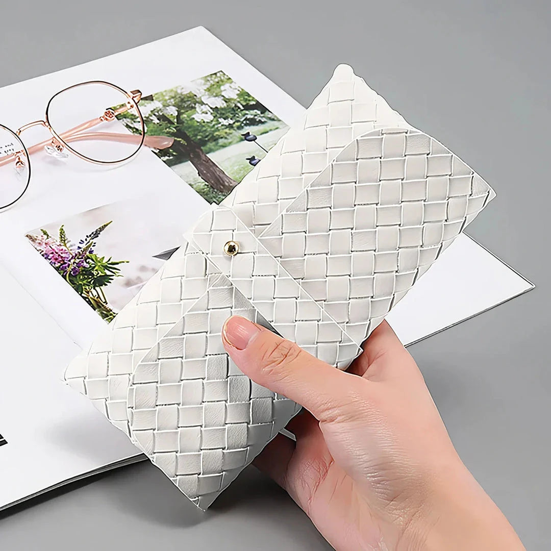 Stylish black and white twist braided leather sunglasses case with snap closure, protecting eyewear in a fashionable way