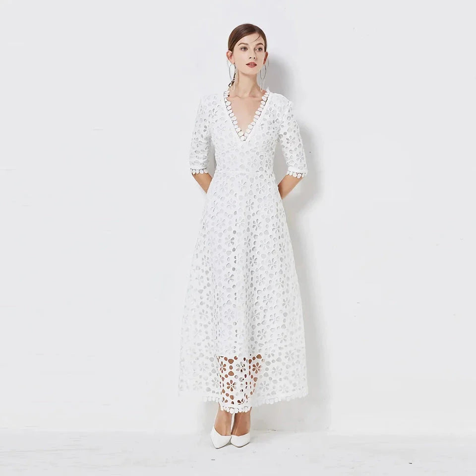 A white lace maxi dress with a stylish V-neck design, perfect for special occasions.