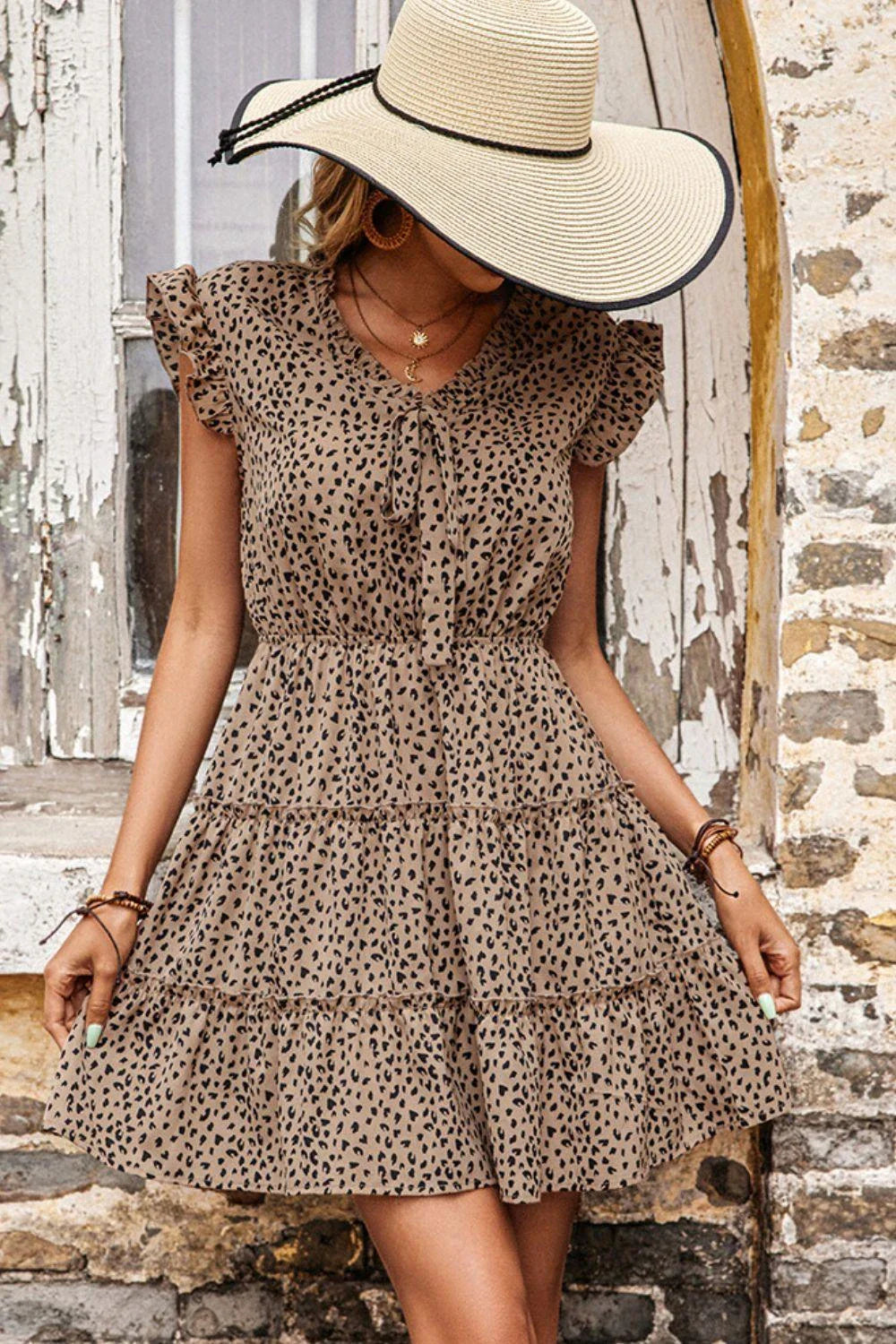 Fashionable leopard print dress with butterfly sleeves and a tiered skirt design