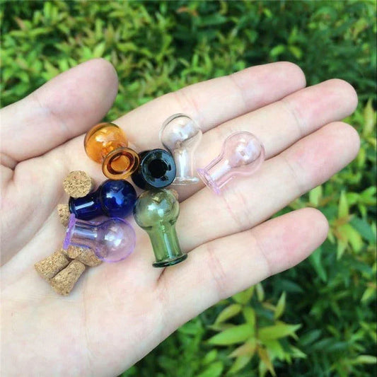 Multicoloured mini glass bottles in a stylish ball shape, perfect for essential oils, trinkets, and decorative accents.