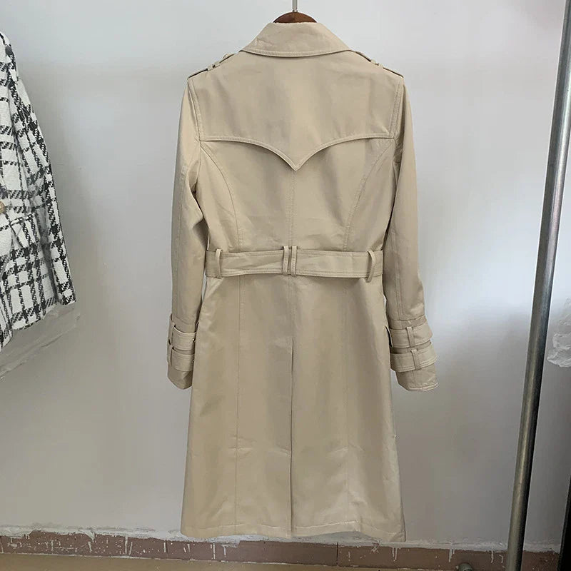 A stylish double-breasted trench coat with a belted waist, made from a cotton-polyester blend for durability and comfort.