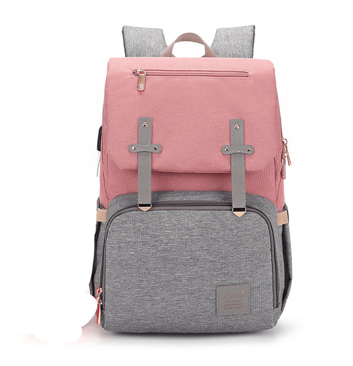 Versatile mum's backpack with pink color, featuring side pockets, zippered compartments, and stroller attachment hooks