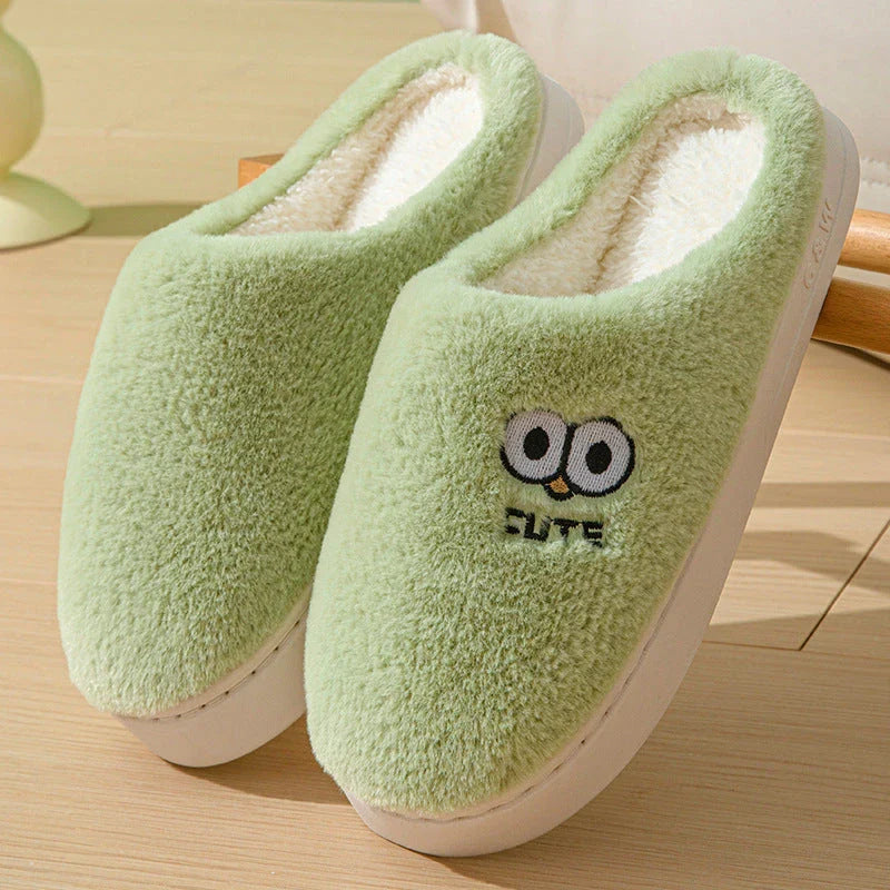 Cozy cartoon slippers with big eyes in various colors, featuring plush material and non-slip rubber soles for comfortable indoor wear