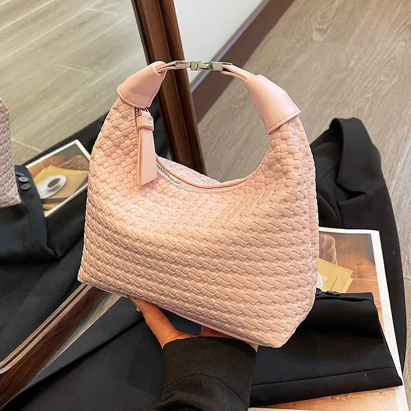 Soft beige PU bucket-shaped messenger bag with an external pocket, shown open to reveal internal document organiser.