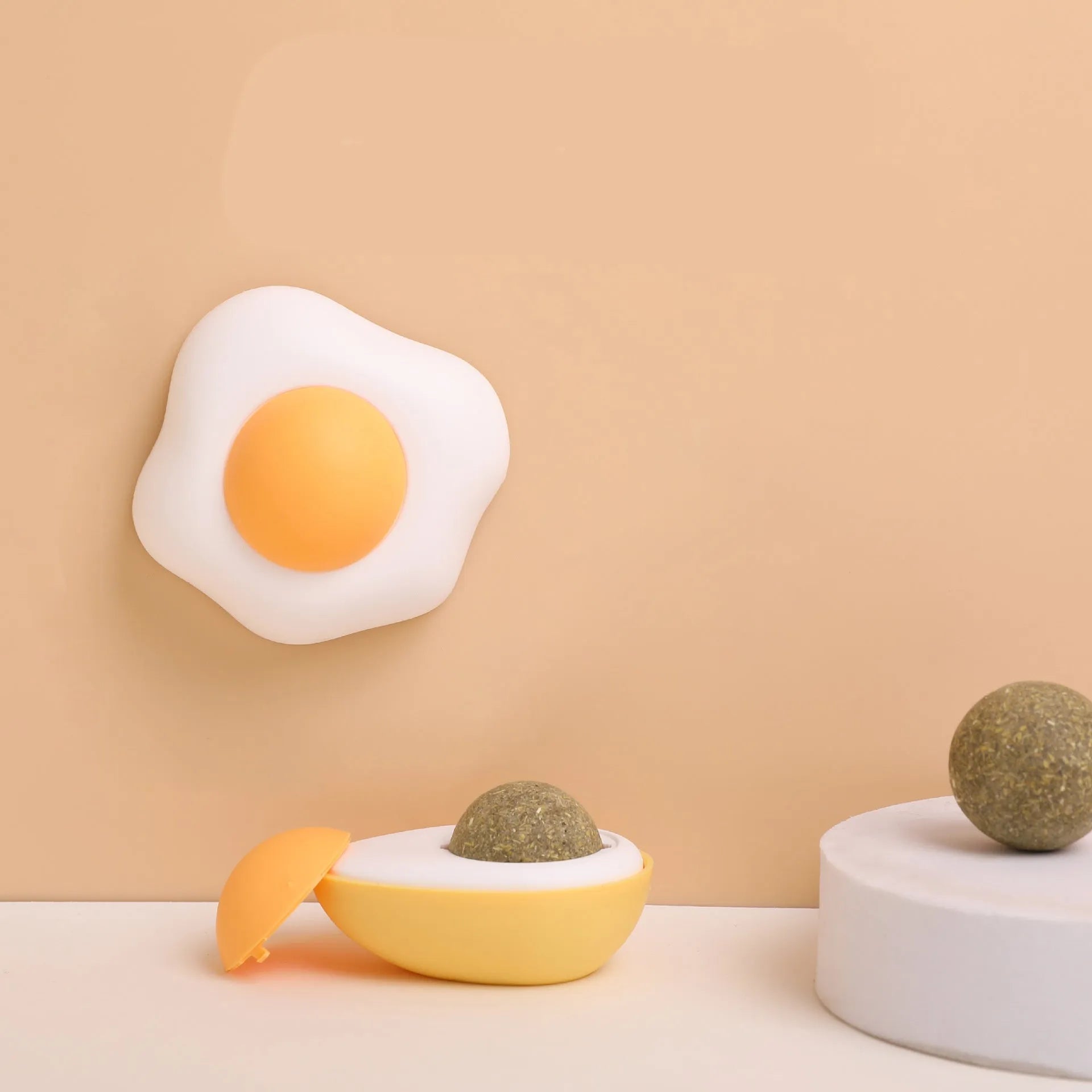 Interactive catnip ball toy for cats in fried egg and poached egg shapes with wall mount feature