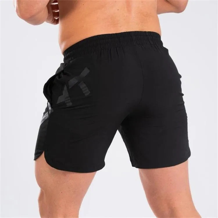 Men's black elastic nylon quick-dry running shorts on a mid-waist, knee-length model.
