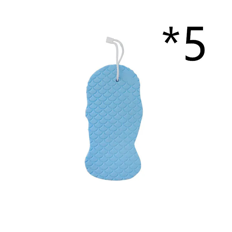 White 3D fish scale pattern bath sponge ball on a bathroom surface.