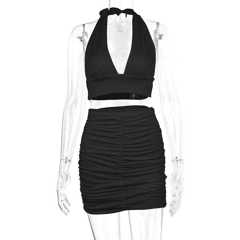 Women's halter lace-up top and pleated skirt set in polyester, available in white, black, and pea green