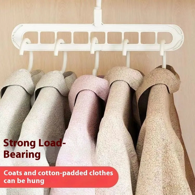 A green nine-hole plastic folding hanger for organising trousers and saving wardrobe space.