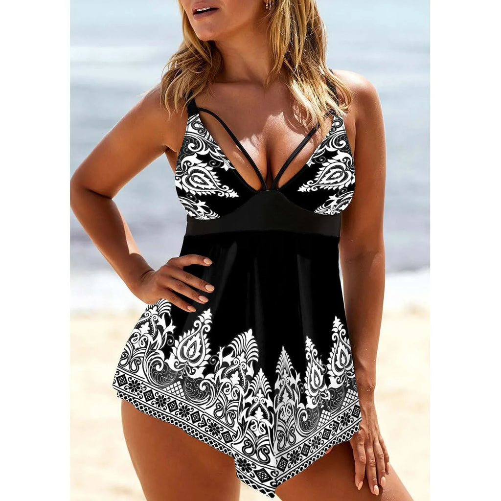 Women's blue plus size swimsuit with deep V-neck, printed straps, and a skirt.