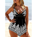 Women's blue plus size swimsuit with deep V-neck, printed straps, and a skirt.