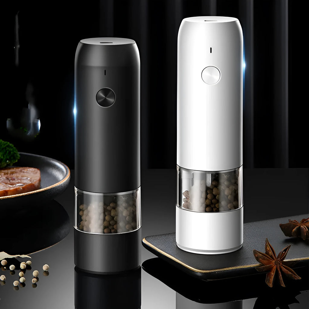 Black and white rechargeable electric pepper and salt grinders with clear acrylic bodies on a kitchen counter.