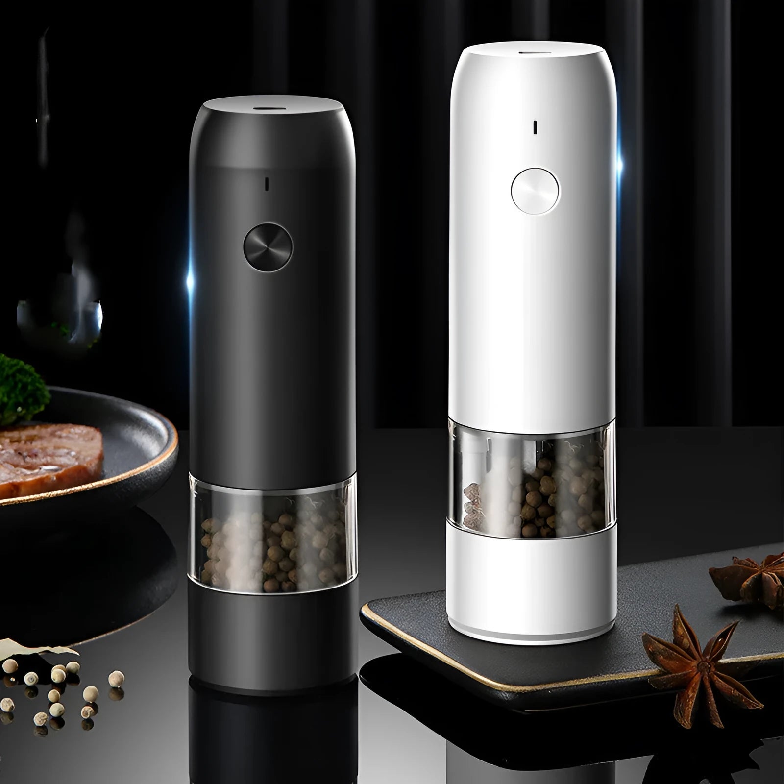 Black and white rechargeable electric pepper and salt grinders with clear acrylic bodies on a kitchen counter.