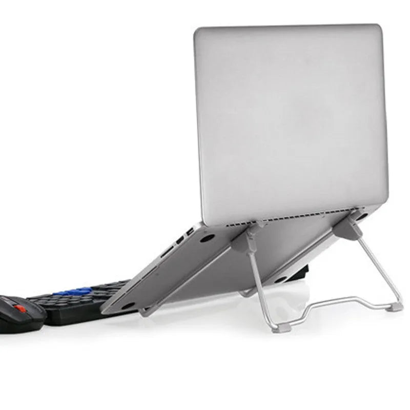 Grey aluminium and plastic mobile phone and laptop stand on a wooden desk.
