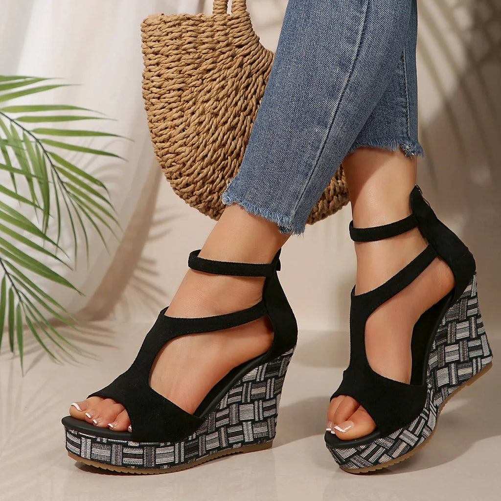 Women's beige wedge sandals with a thick rubber sole and buckle ankle strap on a cloth upper.