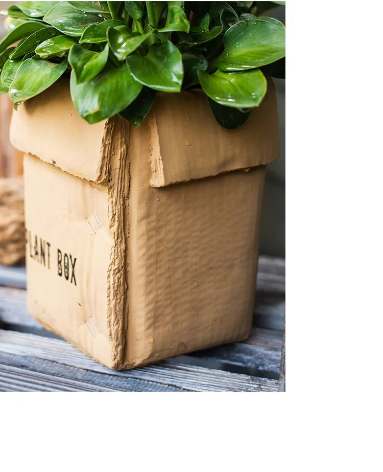 Cement brown paper box style flowerpot with drainage holes for indoor plants.