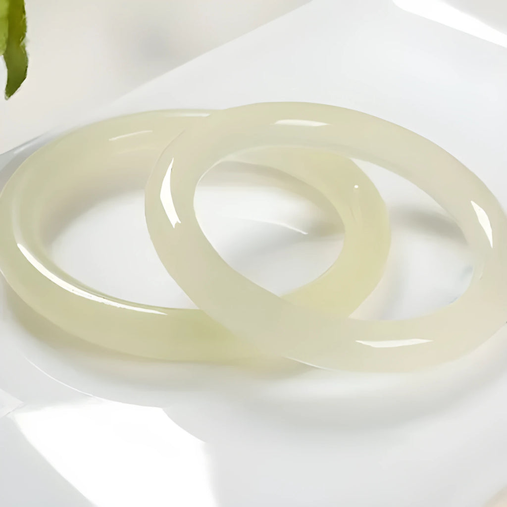 Polished ice-like silk jade round bar bracelet showing its geometric shape and smooth surface
