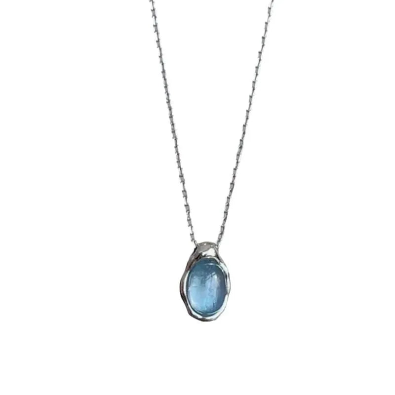 Geometric navy blue water droplet pendant necklace on a platinum-coloured adjustable chain.