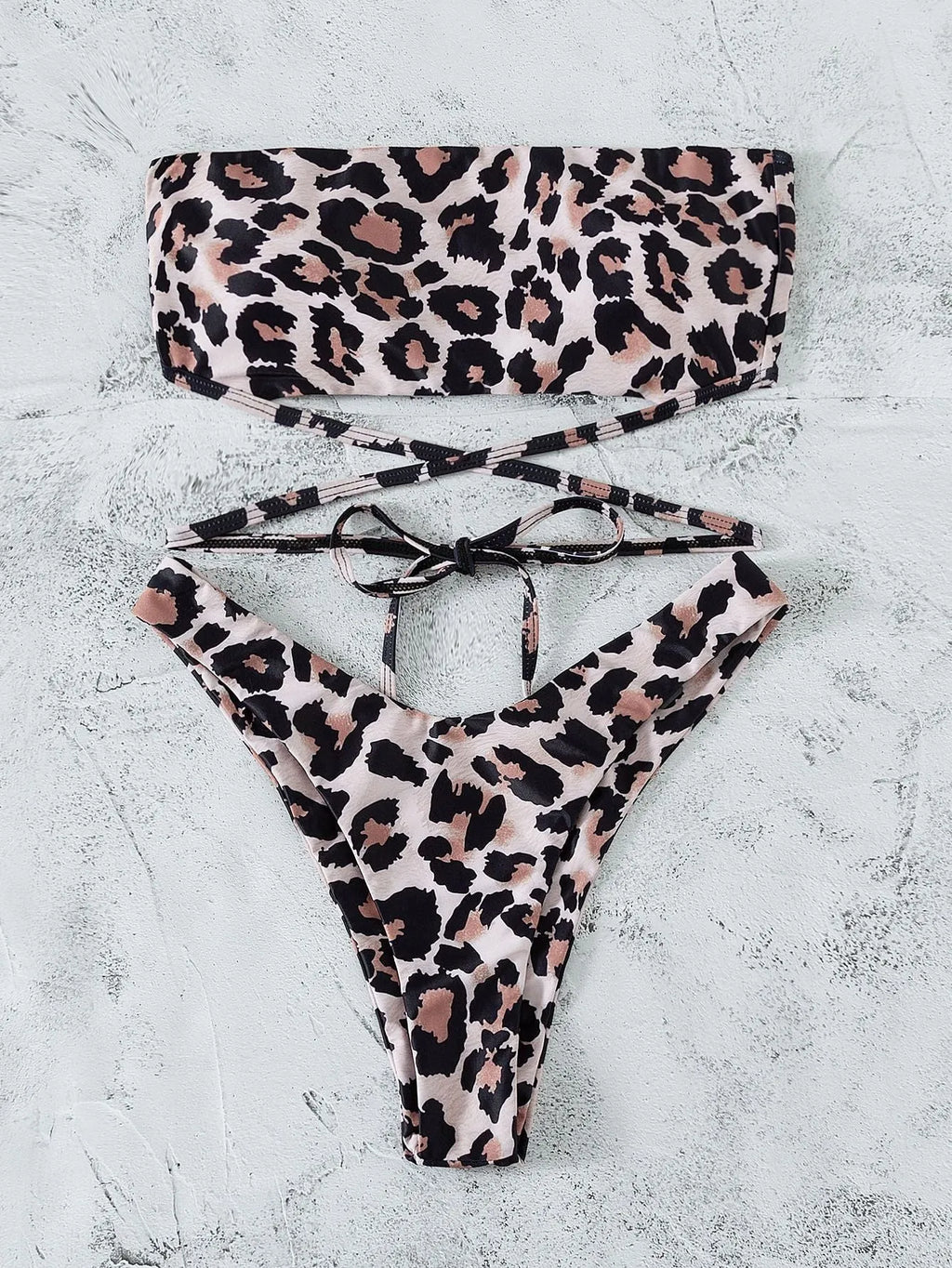 Leopard print bandeau split bikini swimsuit with removable chest pads on woman at beach