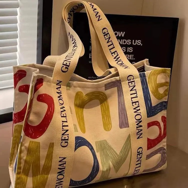 Large canvas women's tote shopping bag with printed design in choice of black letters, coloured letters, or pattern style.