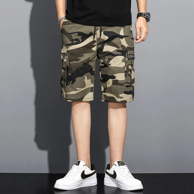 Men's camouflage 5-point workwear shorts in green, front view, with drawstring waist and mid-thigh length