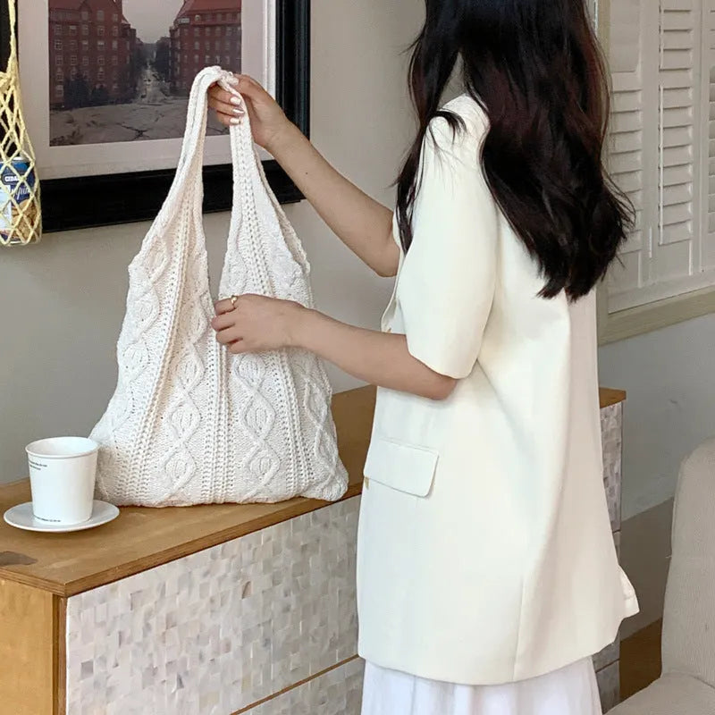 Retro hollow knitted woolen shoulder tote bag in a solid colour with double straps, shown flat displaying its large size.