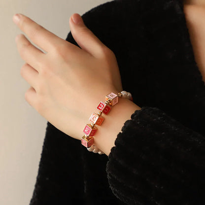 Original design beaded necklace and bracelet set with English letter pendants, perfect for personal expression.