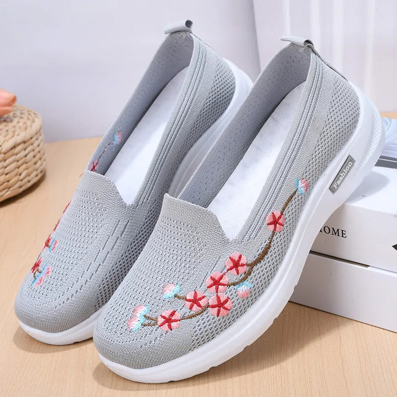 Women's embroidered flywoven casual flat pumps in wine red, shown on a white background.