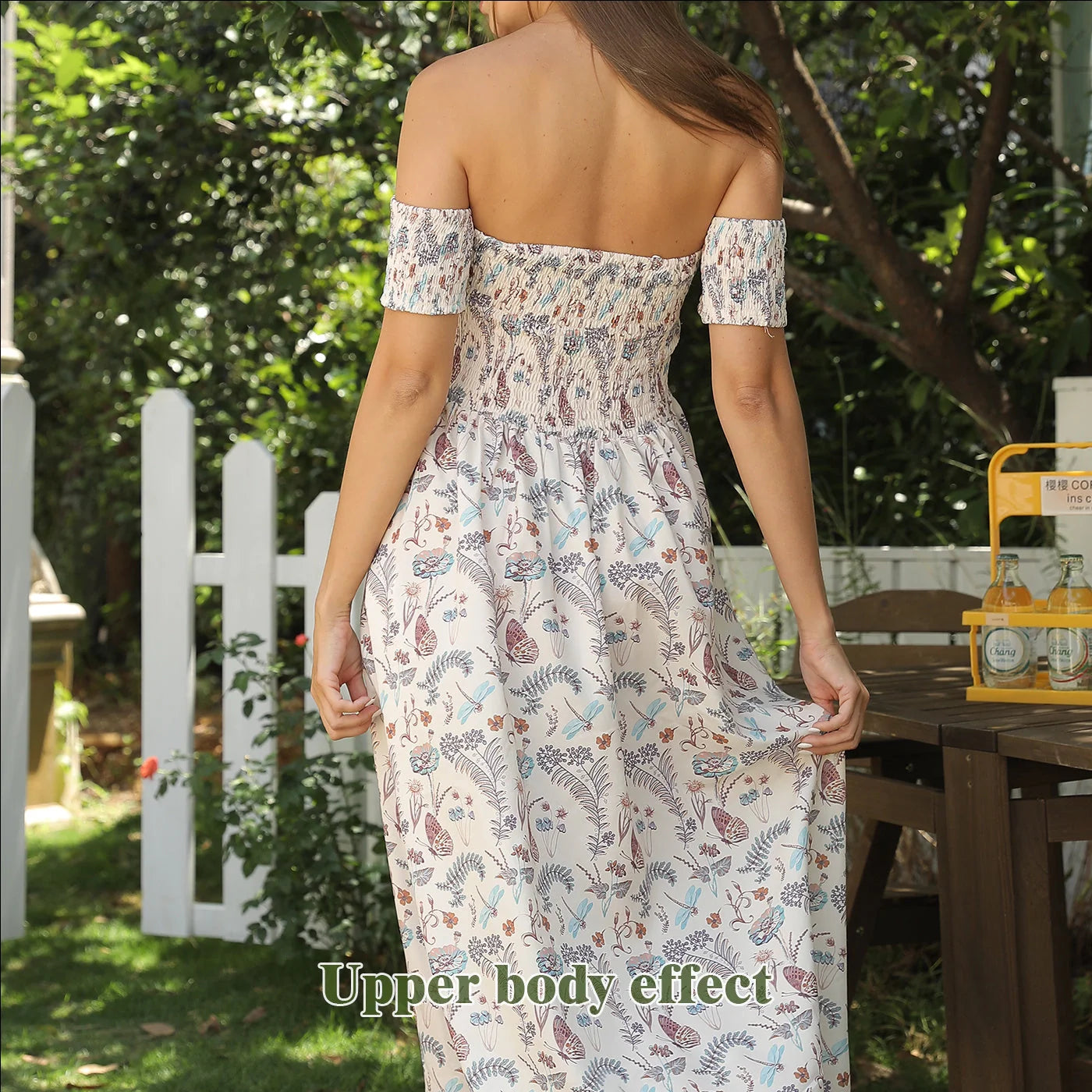Women's off-shoulder strapless floral dress in a vibrant pattern, perfect for summer outings.
