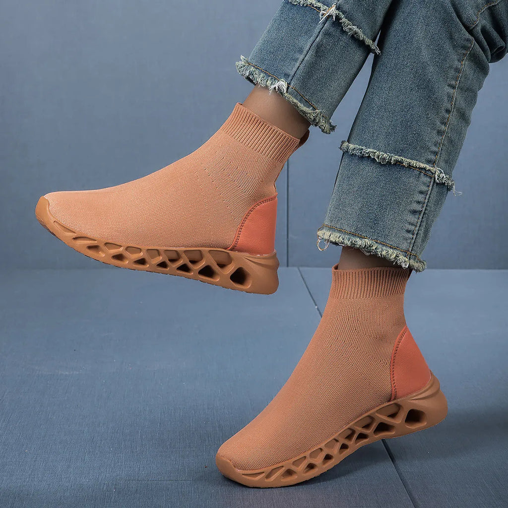Women's terracotta coloured stretch mesh socks boots with flat heel and round toe on a white background.