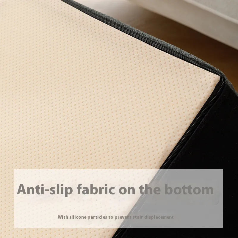 Brown wooden dog stairs with washable fabric cover next to a sofa