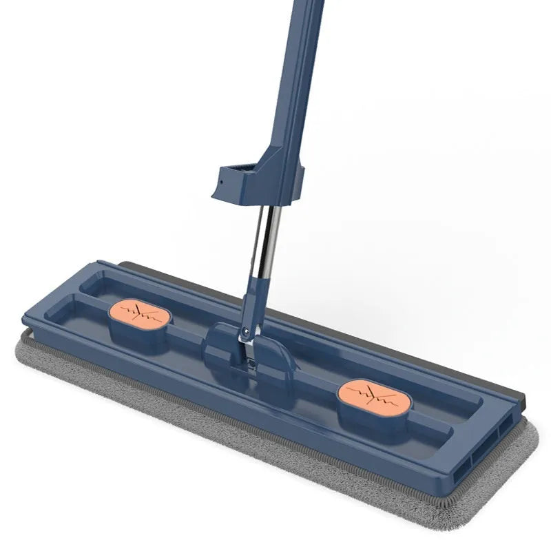 Large flat mop with long stainless steel handle, blue rotating head, and integrated scraper on a hardwood floor.