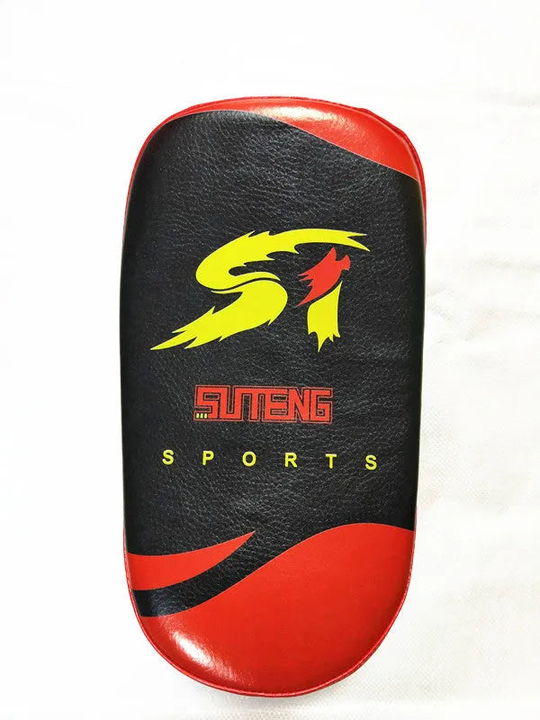 Black and red square martial arts training pad held in hand, showing double buckle strap.