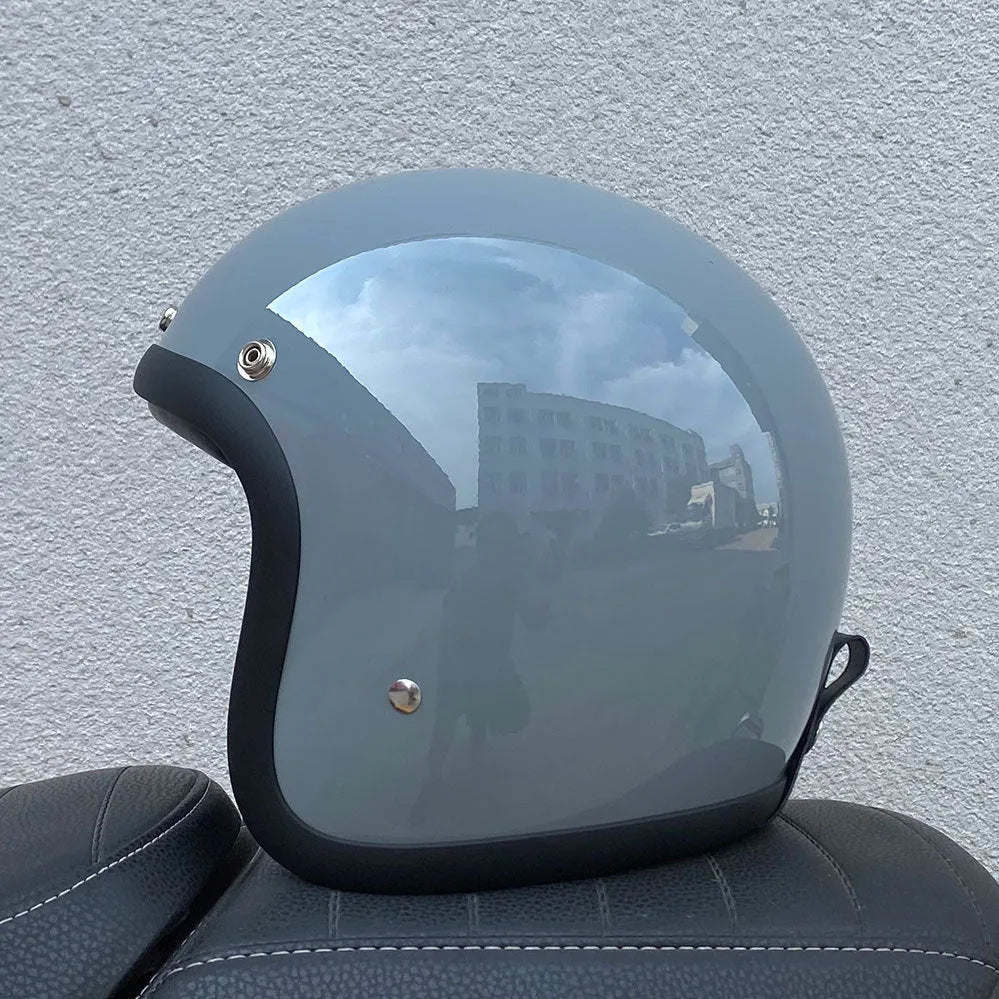 Glass fibre FRP retro half motorcycle helmet shown in a cement grey colour.