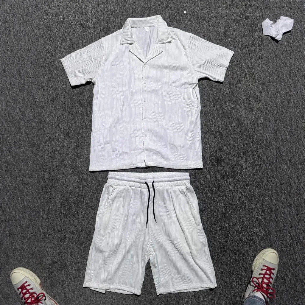 Men's black short sleeve shorts suit with wave pattern texture on cotton blend fabric.