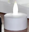 White plastic USB rechargeable LED candle lamp with flickering flame on plastic cup.