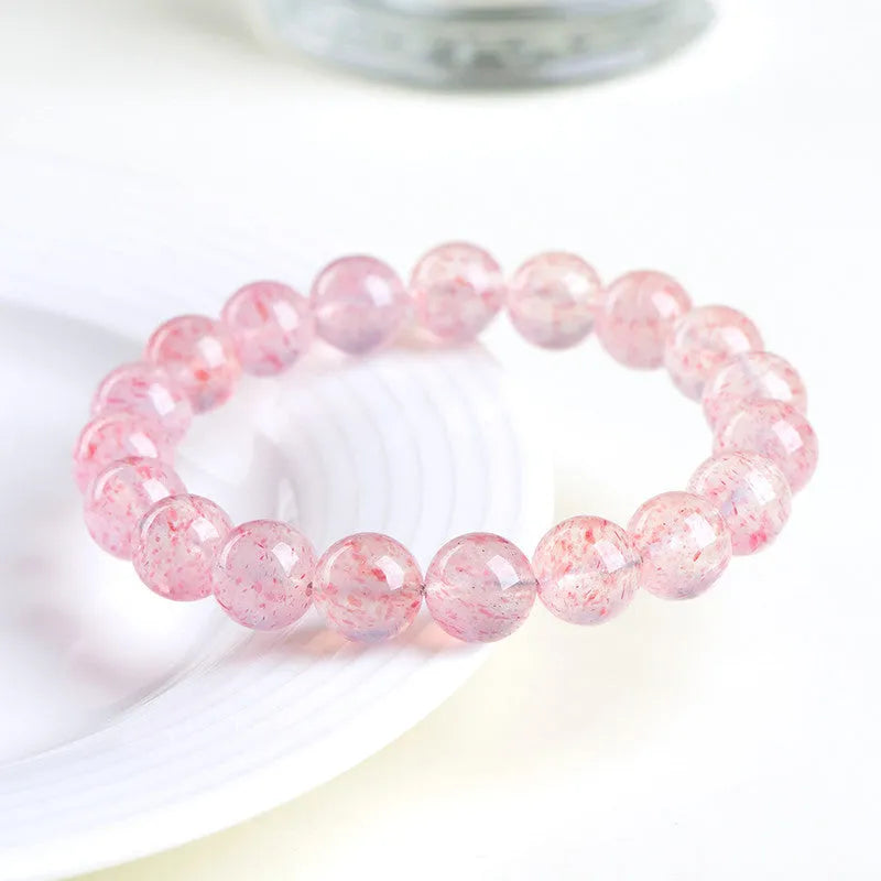 Natural strawberry quartz bracelet with white water crystal beads measuring 10-10.8mm
