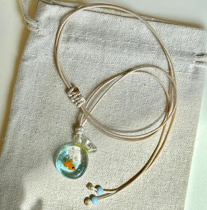Women's skirt-shaped joker pendant necklace on a cotton and linen clavicle chain.