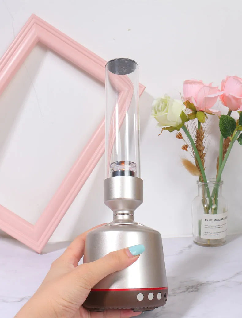 White silver cylindrical Bluetooth speaker and night light unit on a table.