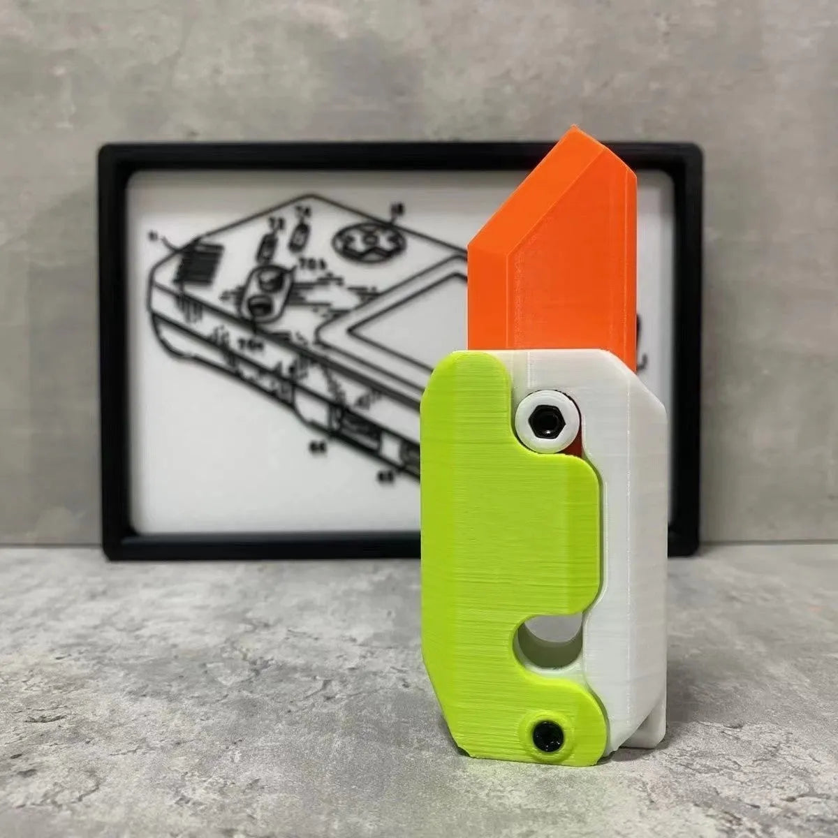 3D printed carrot gravity fidget knife in orange purple green colour, showing blade partly extended from sheath