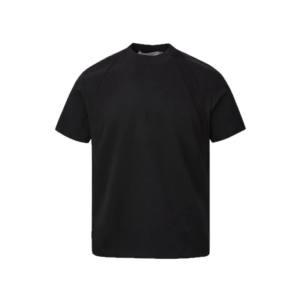 Man wearing a loose grey short sleeve top with visible air layer texture stitching on the front.