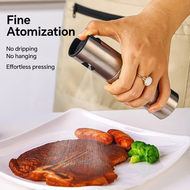Stainless steel press-type oil injection bottle with 100ml capacity and glass body on kitchen counter